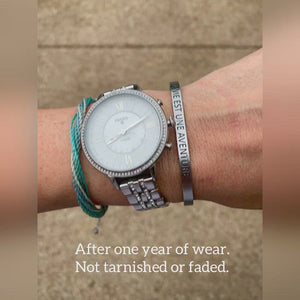 Showing a year of wear and no tarnishing or fading on French language bracelet