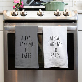 Alexa Take Me to Paris Tea Towel on Stove in Nice kitchen. Both white and gray