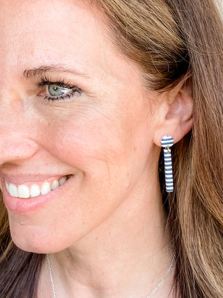 Woman wearing French or Paris striped dangle polymer clay earring black and white